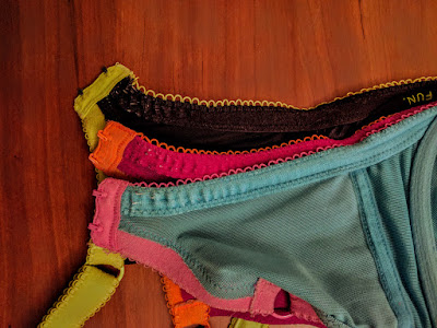 Three bra bands, all with visible wear and tear