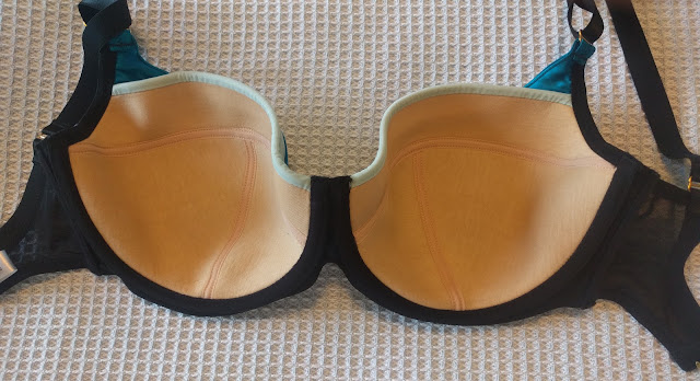 The Lottie laid out on a bed such that the inside of the bra is visible