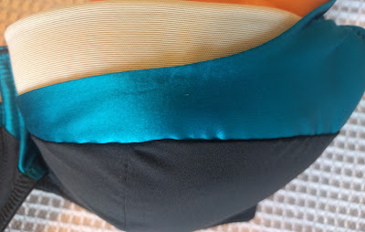 Close up of the three main layers/textures that make up the cup - a black base layer, bright blue silk and a very pale blue powermesh