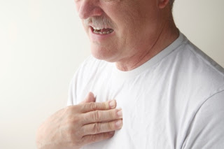 A man touching his sternum in pain