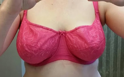 Someone wearing a bra that has lots of space at the top, bottom, middle and sides of the cup